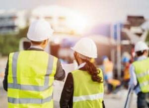 Construction company owner and his father discussing succession plans for the business